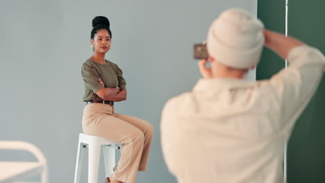 A fashion photoshoot in a studio with a model and photographer