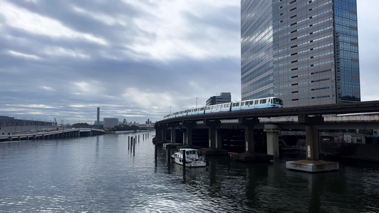 A peaceful riverside view in Tokyo, Japan, with calm water and urban buildings