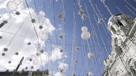 city decorated for holidays with string lights and ornaments