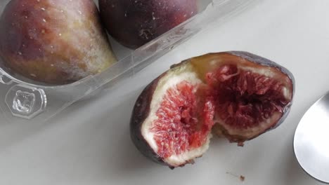 fresh figs with a rich red interior, one sliced to reveal the soft and juicy texture