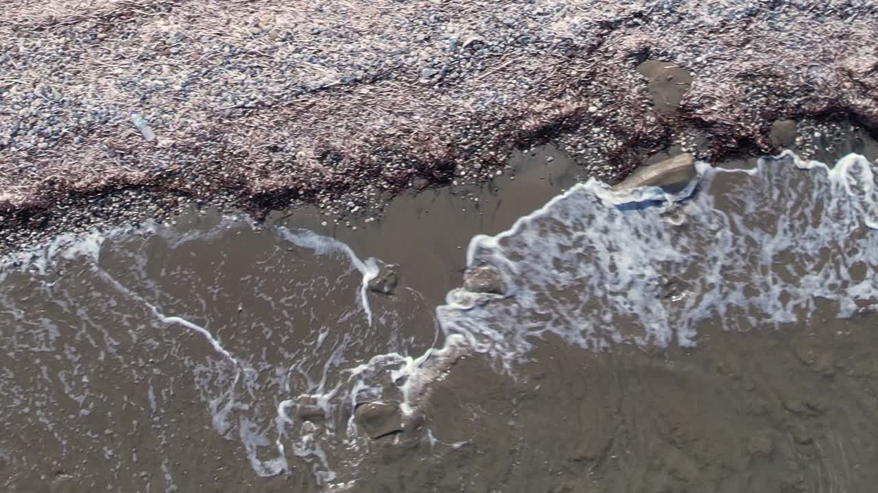 Breathtaking aerial view of a Greek beach with shoreline and waves