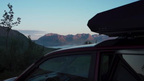 vehicle with roof top tent in a rocky mountain lake background