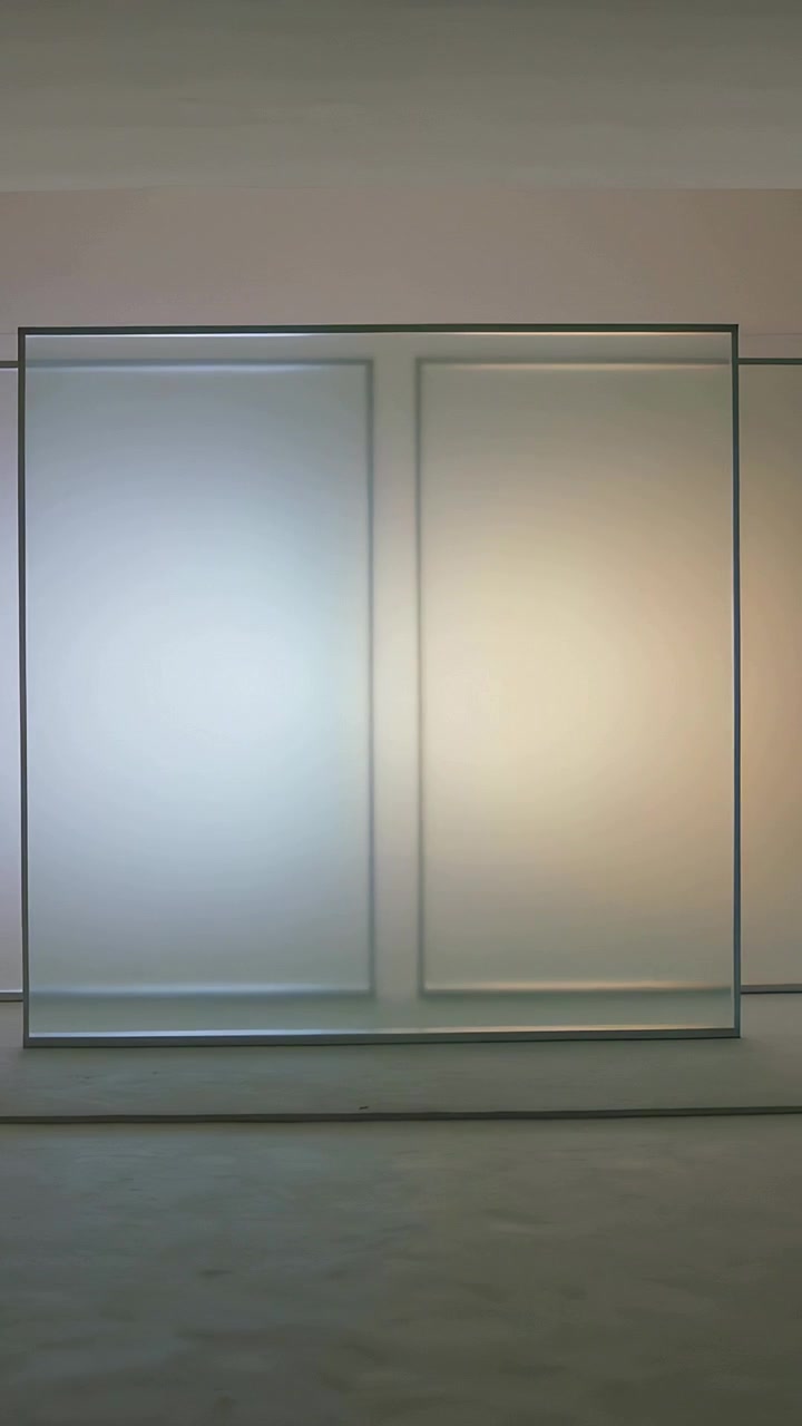Vertical video: Sliding frosted panel along gallery track starting aligning recessed panels backlit