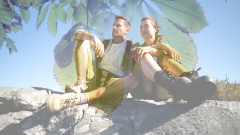 sitting on rocks, hikers resting over animation of green leaves