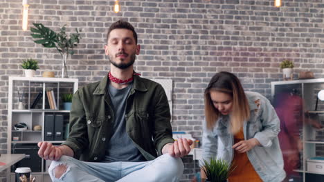 a person meditating in a modern office environment