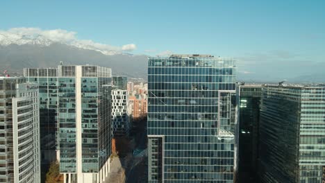 financial center and modern office buildings in nueva las condes, santiago city, chile with sight of snowcapped andes ranges in the background