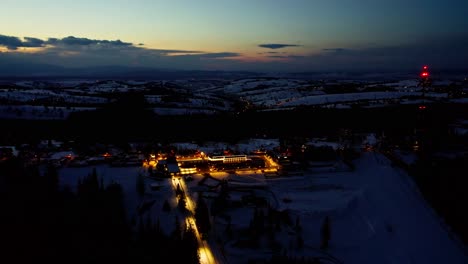 Winter-Landscape-Of-Zakopane-With-Lights-Illuminating-At-Night---aerial-drone-shot