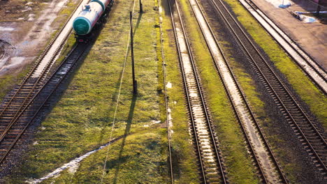 parallel raidroad tracks with standing waggons and engine, aerial flyover, valmiera, latvia