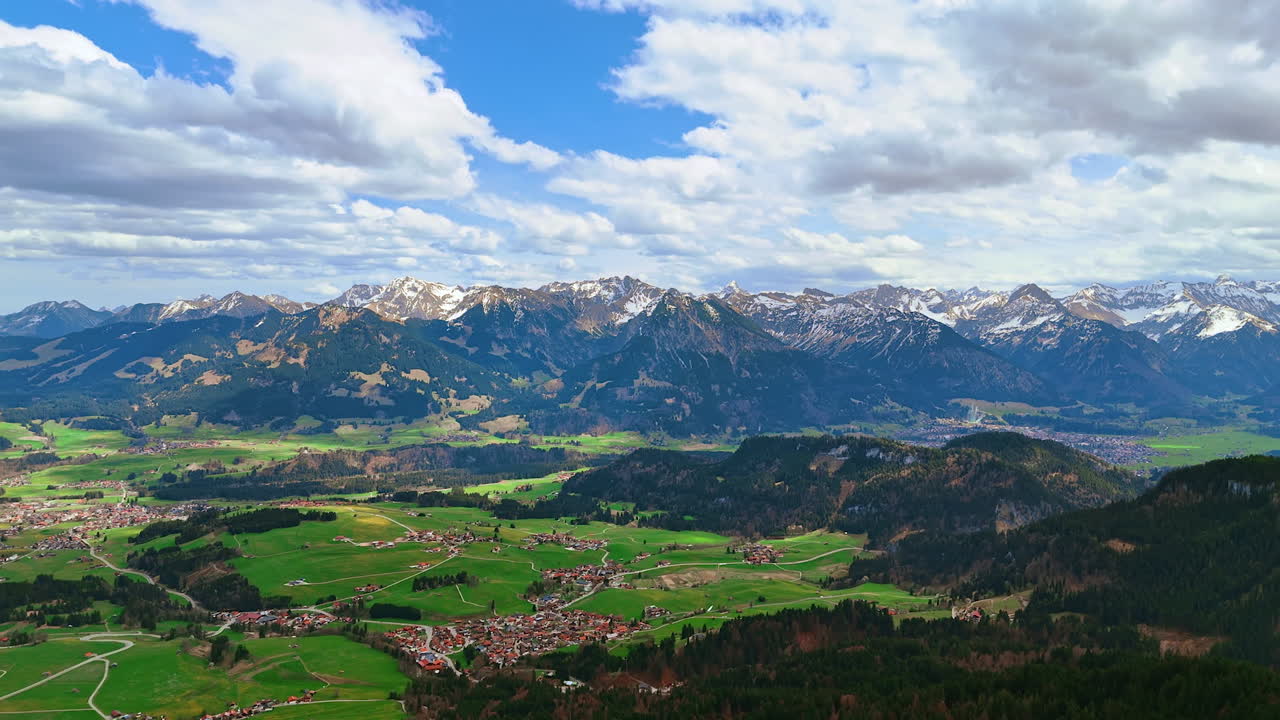 Spectacular scenery of Bolsterlang, Bavaria, Germany situated in the valley surrounded by the mountains. White clouds cover the sky above the view. Aerial perspective.