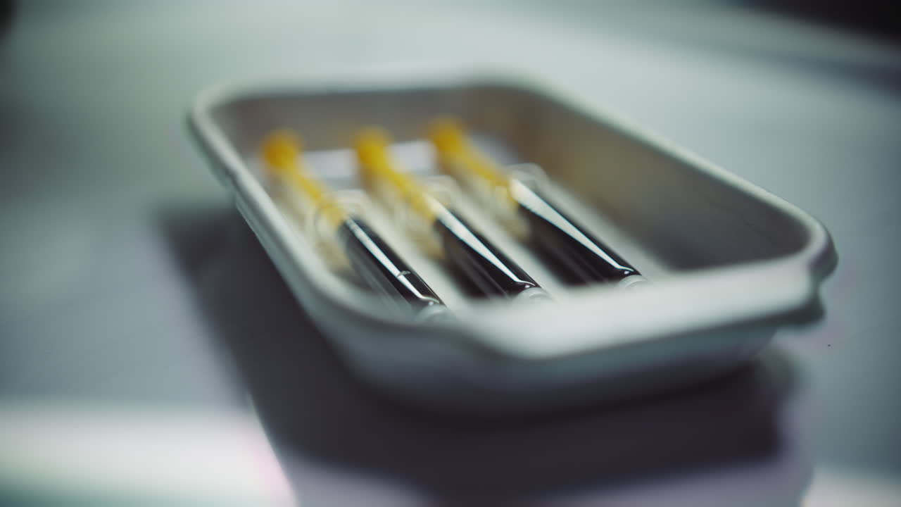 Syringes with a dark liquid on a medical tray
