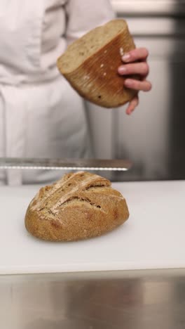 chef cutting a loaf of bread
