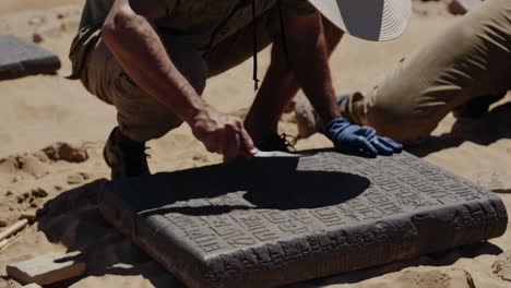 archaeologists excavate ancient inscriptions in the desert