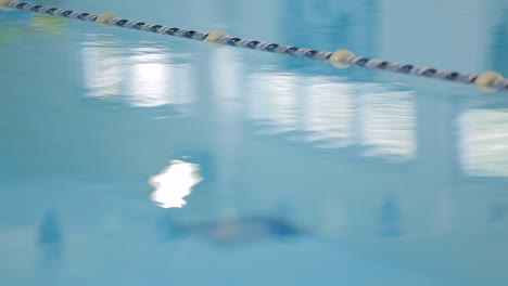 static shot close up of an indoor pool with gentle water ripples