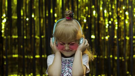 Child-dances,-listens-music-on-headphones.-Little-kid-girl-dancing,-having-hun,-relaxing,-enjoying