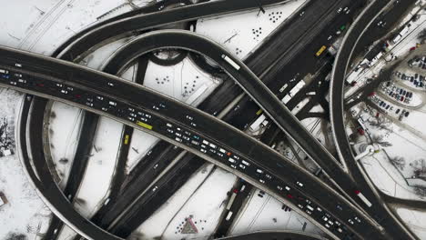 Aerial-view-car-jam-on-freeway-in-winter-city.-Cars-motion-on-road-intersection