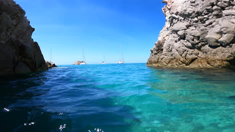 action cam dives underwater near a small greek