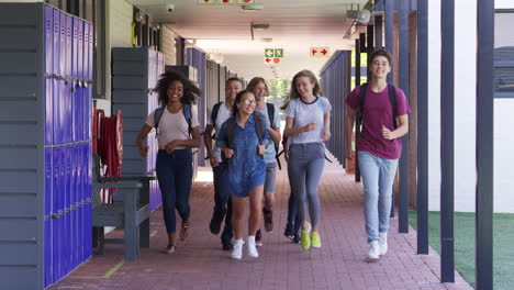 teenage school kids running in high school hallway