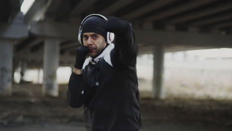 man boxing workout under an overpass