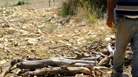 Man-cutting-wood-with-chainsaw-countryside