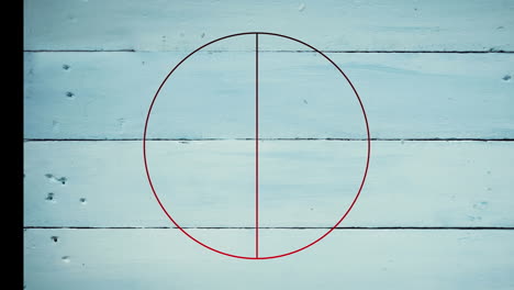 animation of red line in circle over white wooden table