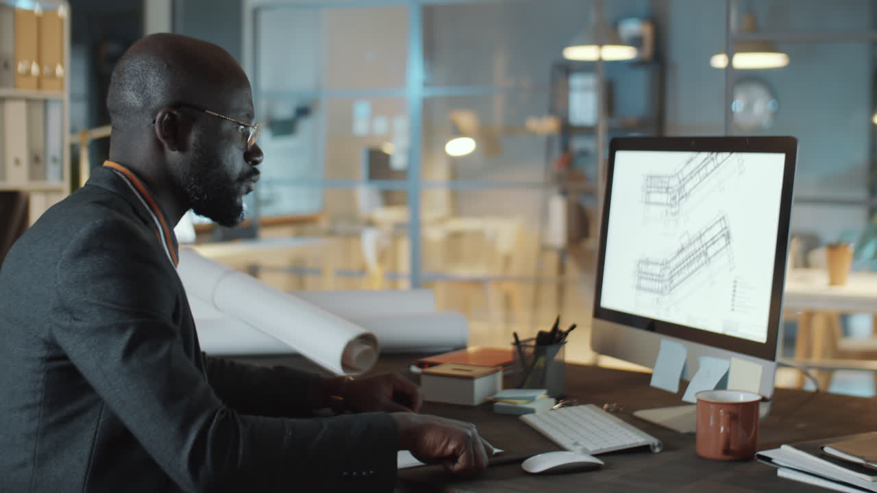 African American Engineer Working on Computer at Night in Office