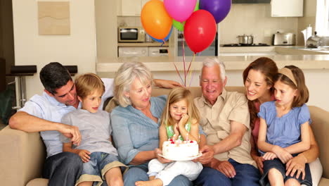 extended family celebrating little girls birthday on couch