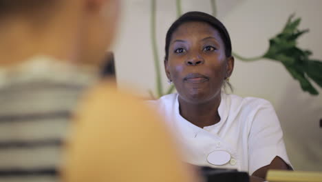 receptionist at beauty spa consulting the client