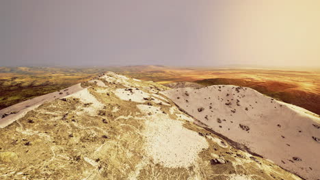 vast landscape of rolling dunes and hills in afternoon golden light