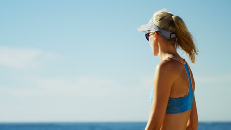 Female-volleyball-player-standing-in-the-beach-4k