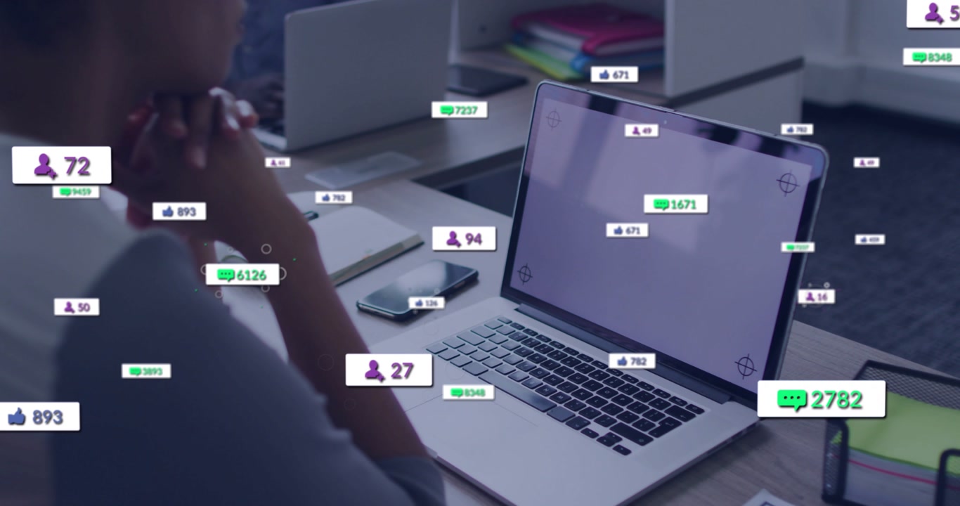 Woman sitting at laptop, screen starting social badges clustering near laptop fading showing spike