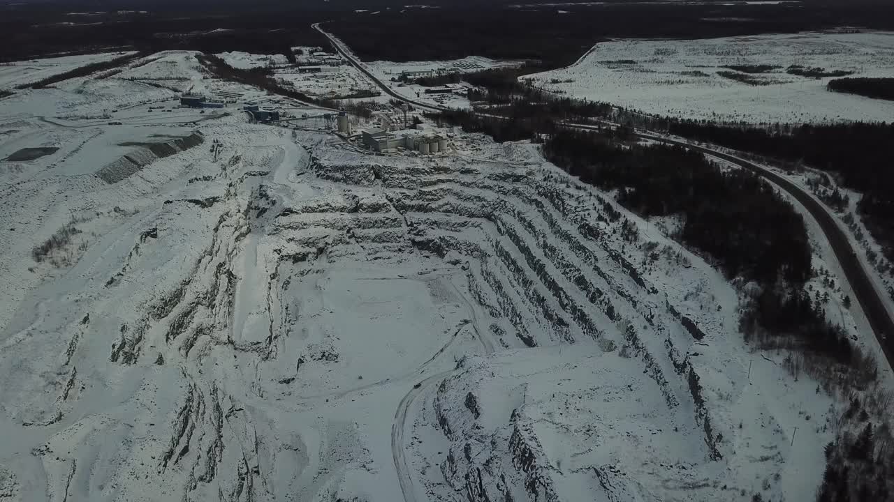 Quarry and oild and gold mine hole in forest in Canada pan up - Drone 4k Aerial