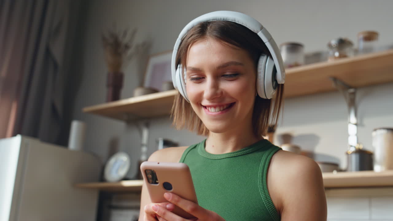 Woman listening to music with headphones and using mobile phone