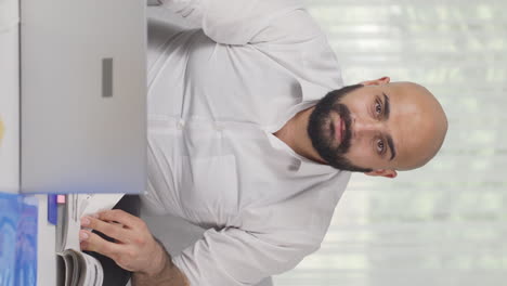 Vertical-video-of-Ambitious-and-determined-portrait-of-home-office-worker-man.