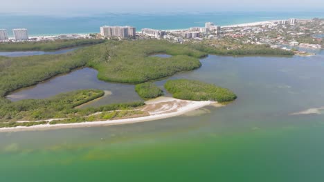 Aerial-view-of-Florida-mangrove-tunnels-with-Lido-Key-city-skyline-in-the-background