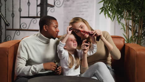 white woman with daughter and black husband points to film