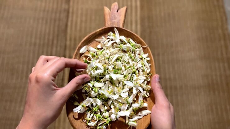 Pomegranate shape wooden handmade plate caving workshop and organic orange blossom flower bud amazing aroma taste and the pattern of nomad local people manmade wicker in northern middle east
