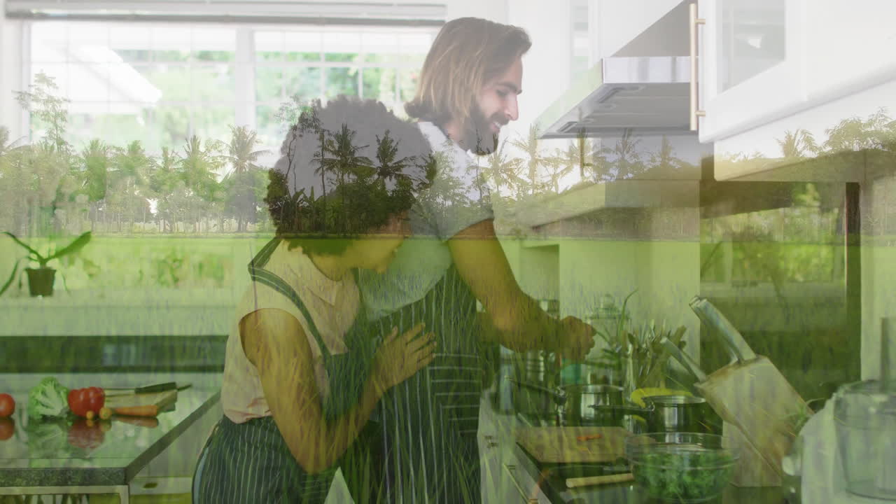 Cooking together in kitchen, couple with tropical landscape animation overlay