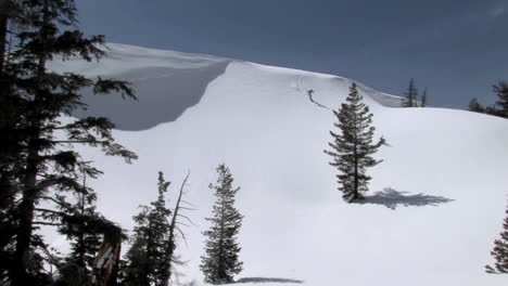 long shot of a snowboarder on a pristine mountain slope