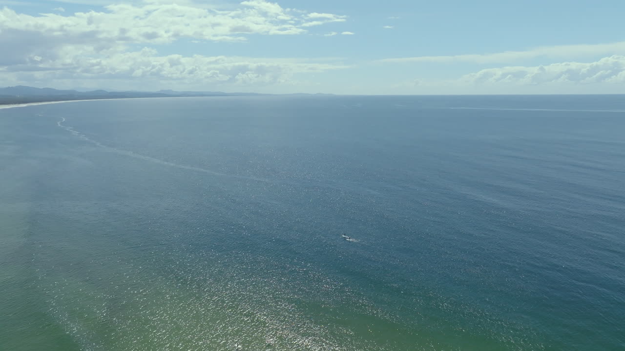 Aerial drone shot of Byron Bay coastline on a sunny day