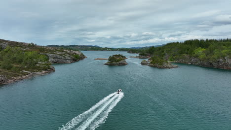 drone following a boat between islands in davangar western norway