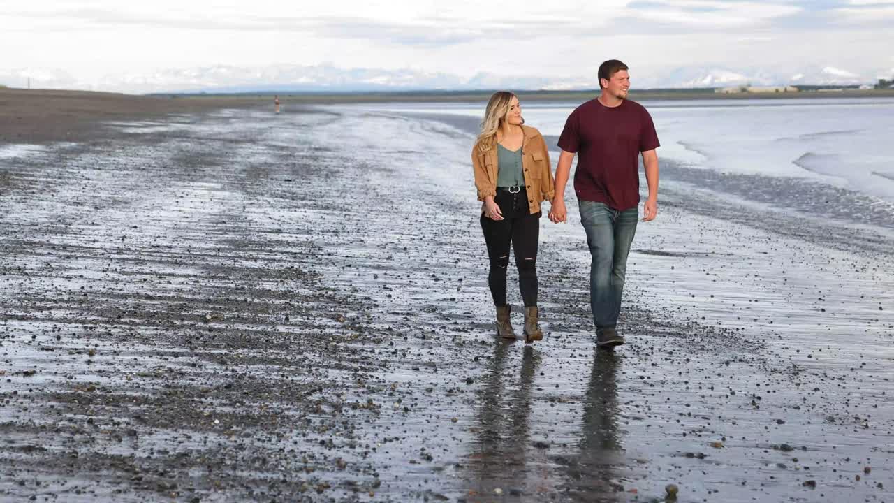 Couple walking on beach in Kenai, Alaska