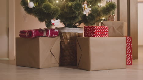 wrapped gifts under the christmas tree decorated with elements and christmas lights 1