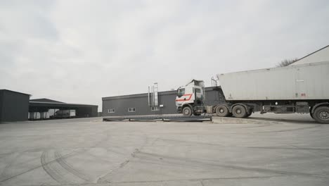 truck with raw materials is weighed on the scales in the grain storage area. truck scales