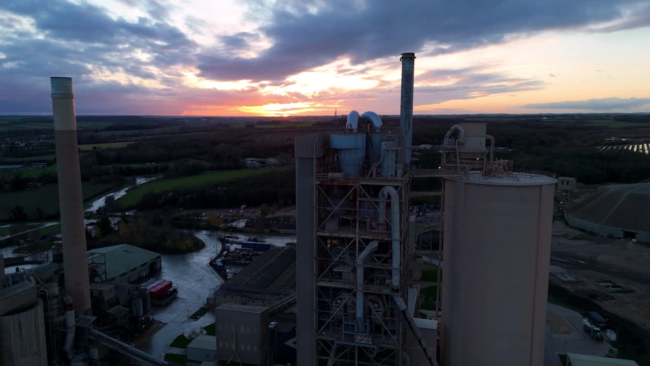 Aerial View Of Expansive Cement Processing Plant With Tall Silos And Manufacturing Facilities In British Countryside