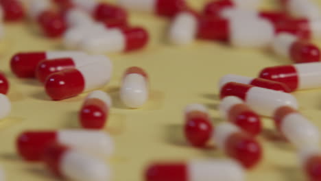 slow motion close-up of a single pill as several pills roll by and push it out of frame