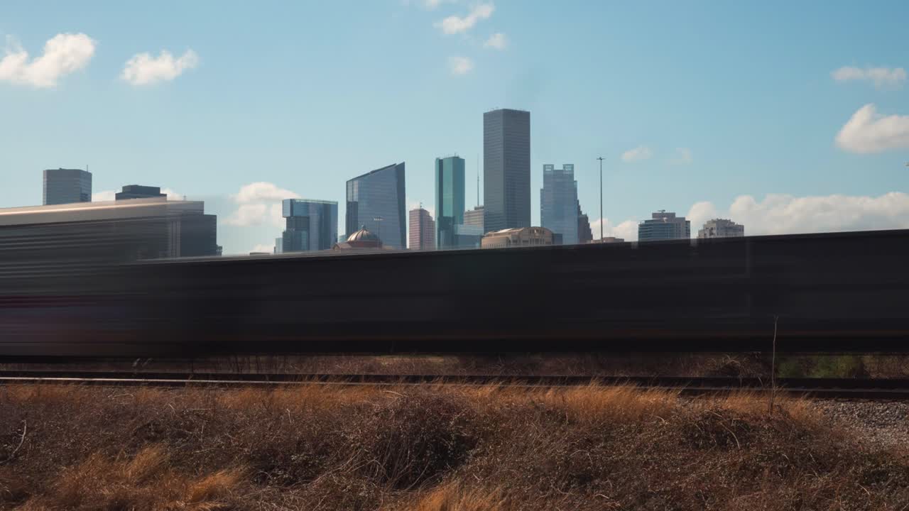 Time lapse of cargo train passing by downtown Houston, Texas