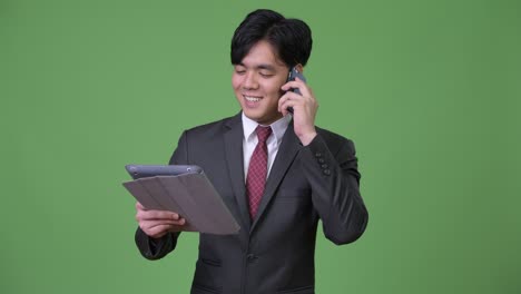 young handsome asian businessman using digital tablet
