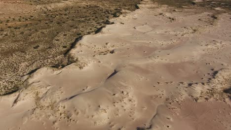 aerial view of massive sand dunes among rocky mountains in the arid region of the northern cape, south africa