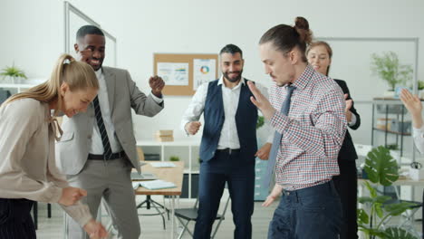 happy office team dancing