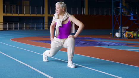 senior woman stretching indoors